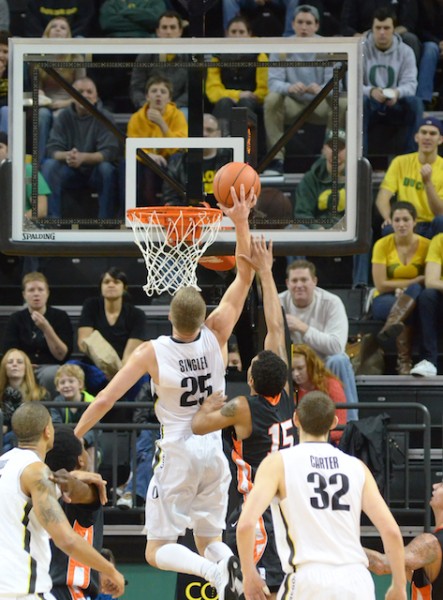 E.J. Singler leaps in for a put-back off of Damyean Dotson's missed three-pointer. (Photo by Rockne Andrew Roll)
