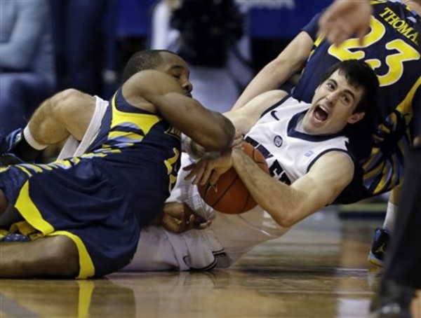 Butler guard Alex Barlow, right, and Marquette guard Derrick Wilson fight for a loose ball in the first half of an NCAA college basketball game in Indianapolis, Saturday, Jan. 18, 2014. (AP Photo/Michael Conroy)
