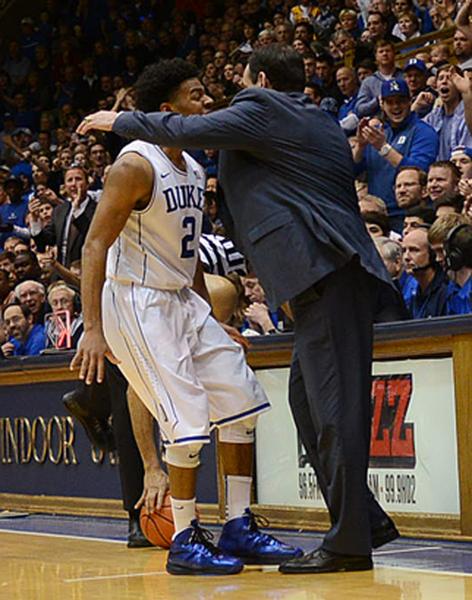 Quinn Cook gets a hug from his coach after leading Duke to victory without Jahlil Okafor. (Bernard Thomas/The Herald-Sun)