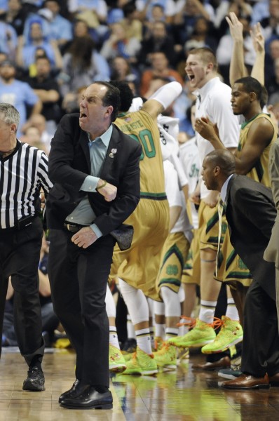 Mike Brey celebrates Notre Dame winning its first ever conference tournament. (Photo by Liz Condo, theACC.com)