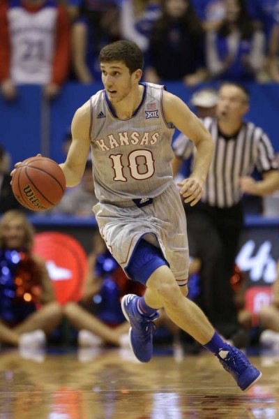 Will the allure of playing time created by roster defections be enough to keep Svi Mykhailiuk in Lawrence? (AP)