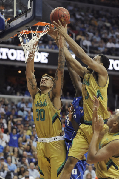 Notre Dame forward Zach Auguste (30) and Notre Dame forward V.J. Beachem (3) grab a rebound during the quarterfinals of the 2016 New York Life ACC Tournament in Washington, DC, Thursday, March 10, 2016. (Photo by Liz Condo, theACC.com)