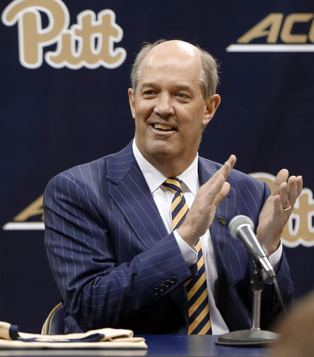 Kevin Stallings claps for the Pitt band as he arrives at his introductory news conference as the new head coach for the Pittsburgh basketball team on Monday, March 28, 2016, in Pittsburgh. (AP Photo/Keith Srakocic)
